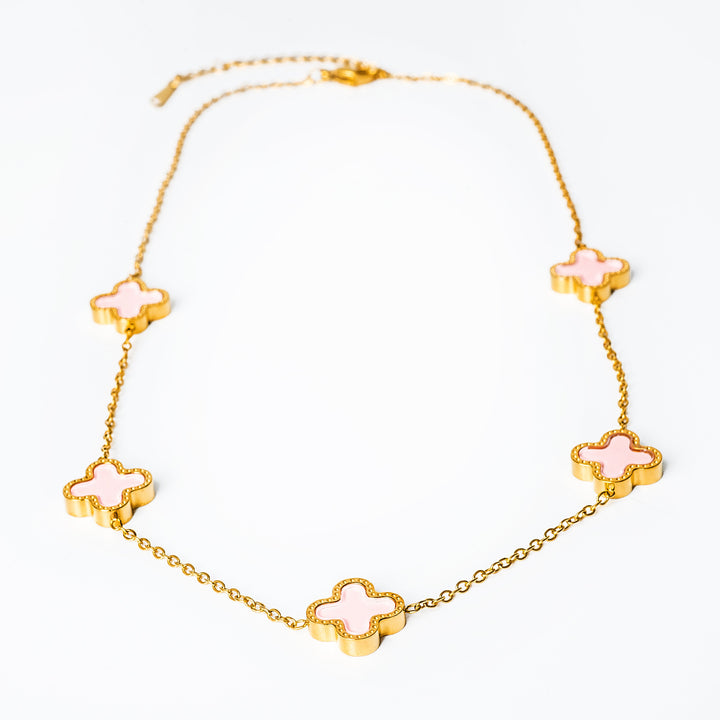 A close up view of Fiorella Necklace in pink colour standing in the center of the image against a white background. 