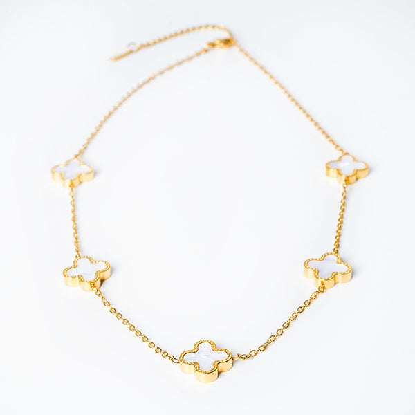 A yellow gold stainless steel necklace with white enamel accents in the shape of crosses.