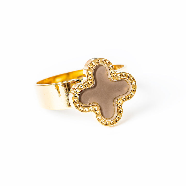 A close up view of Fiorella Ring gold colour standing in the center of the image against a white background. 