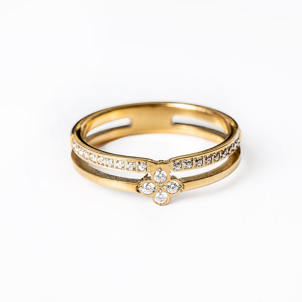 A close up view of Fleur Gold Ring standing in the center of the image against a white background. 
