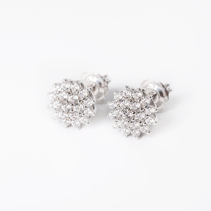 A close up, side view of Flora Earrings standing against a white background. 