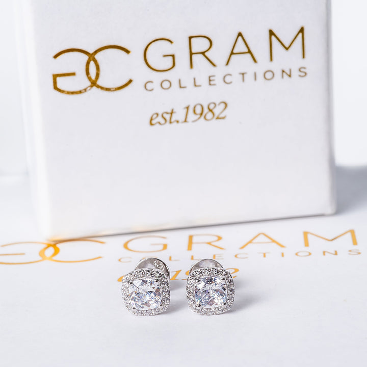 Florian Earrings placed on its white box. 