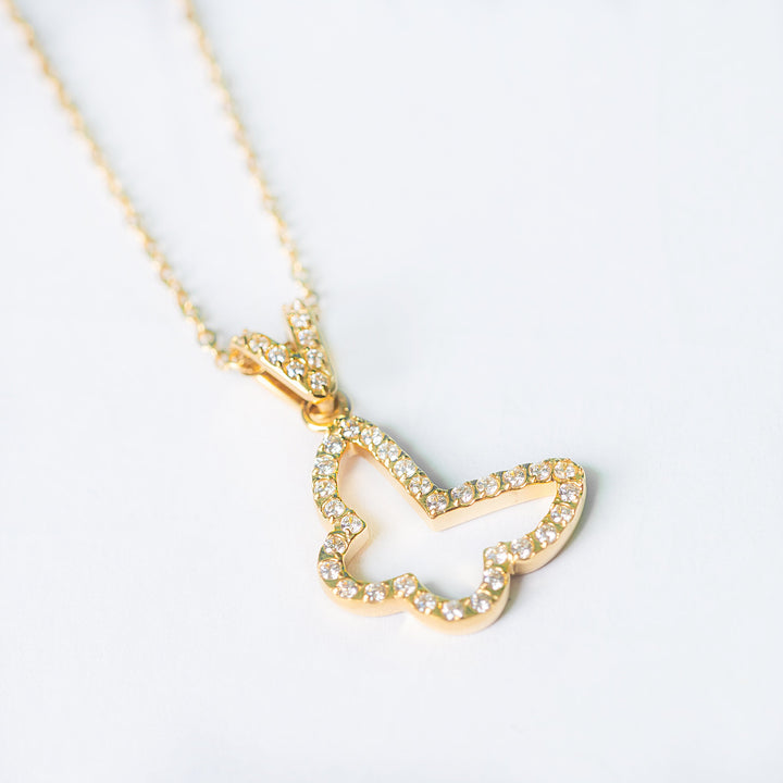 Gold Francesca necklace with an open butterfly pendant accented with small sparkling stones on a white background