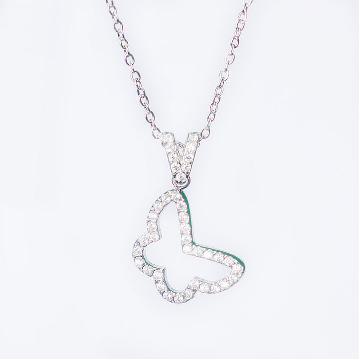 Silver Francesca necklace with a crystal-outlined open butterfly pendant shown in a close-up on a light background
