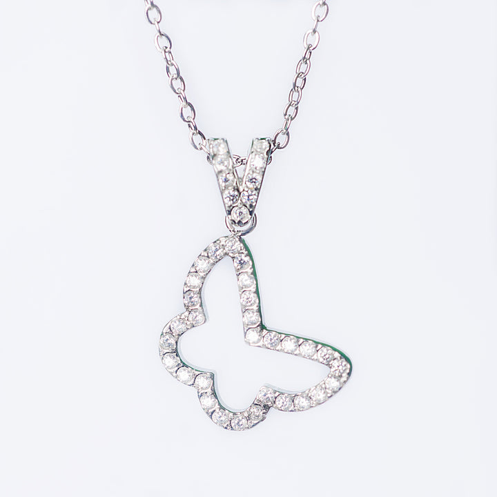 Silver Francesca necklace with an open butterfly pendant lined with sparkling stones on a light background