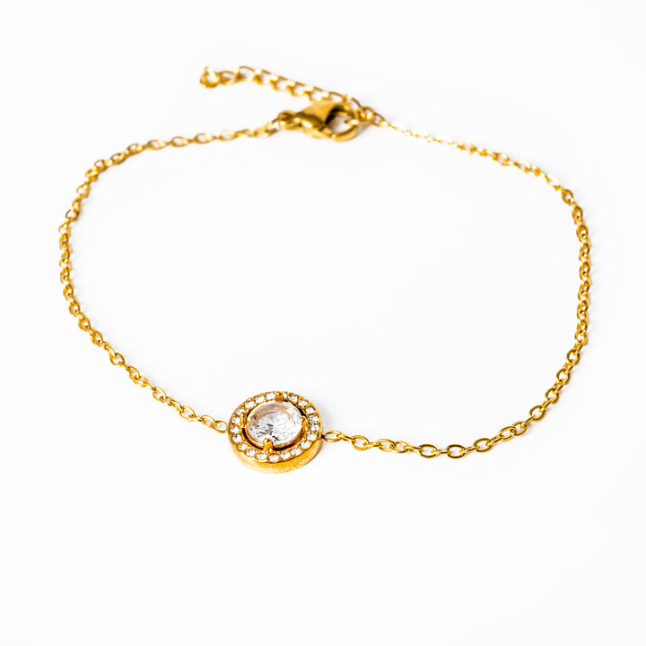 A close up view of Gabby Gold Bracelet standing in the center of the image. 