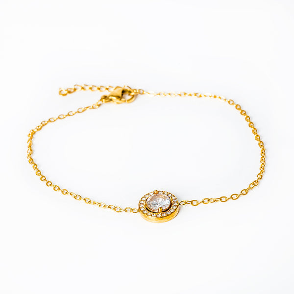 A yellow gold-plated stainless steel bracelet with a central cubic zirconia gemstone, hypoallergenic and tarnish-free.