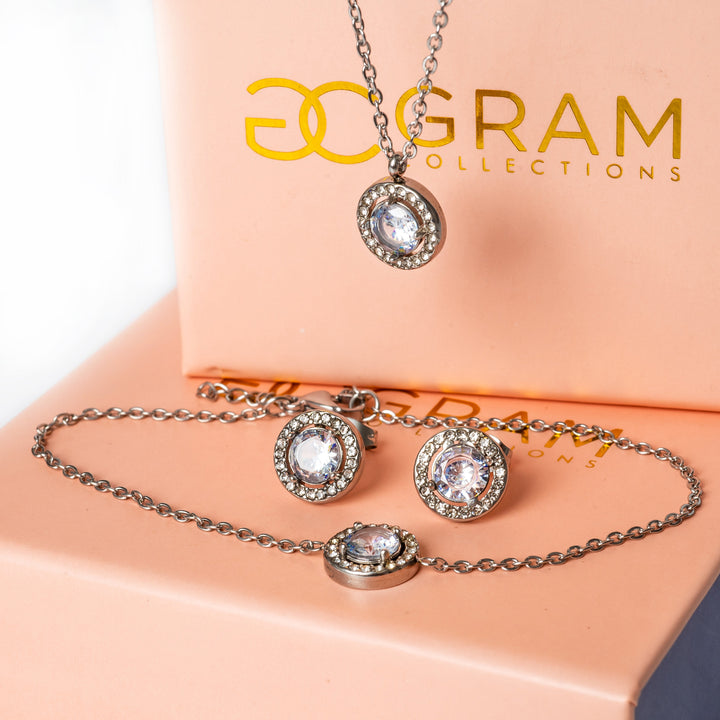 Gabby Silver Earrings standing in the center of the image placed on its box. 