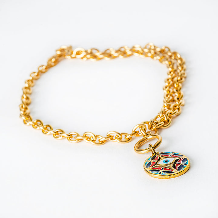 Gold chain Ghajn bracelet with a colorful pendant on a white background