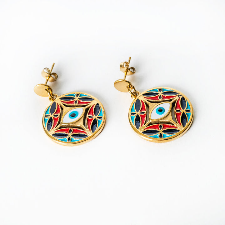 Pair of gold Ghajn earrings with colorful circular designs on a white background