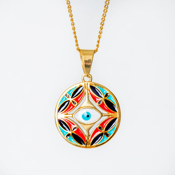 Gold Ghajn pendant with colorful design on a white background