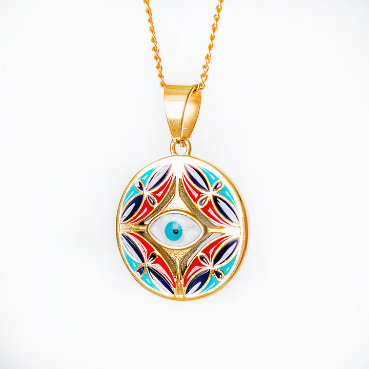 Colorful  Ghajn pendant with eye design on a gold chain against a white background