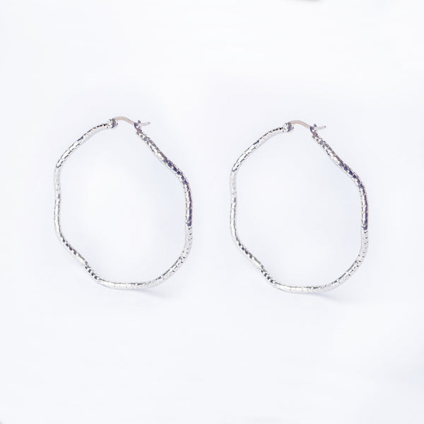 A pair of silver-colored stainless steel Grace hoop earrings on a white background
