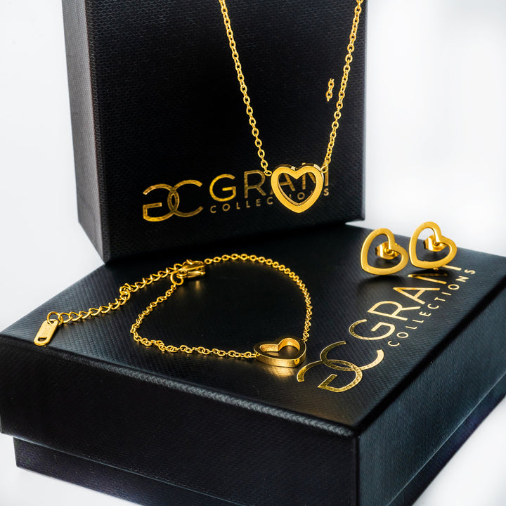 Amata Gold Necklace standing in the center of the image placed on its uniquely designed box. 