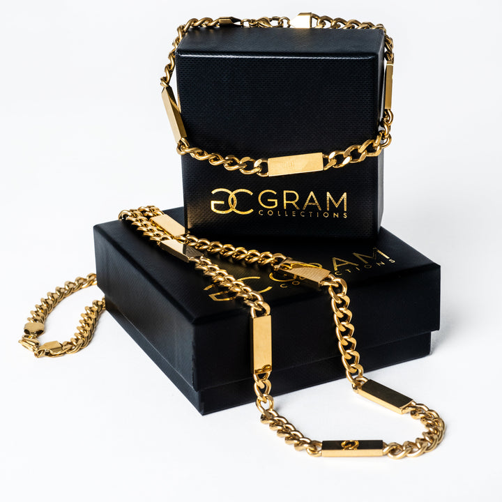 A close up view of Gram collections's Bar Necklaces in two sizes placed on their two uniquely designed box, in the center of the image, facing white background.