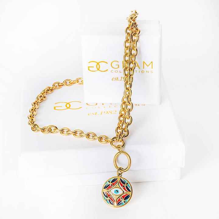 Gold chain bracelet with a colorful pendant on a white background with 'Glam Collection' branding.