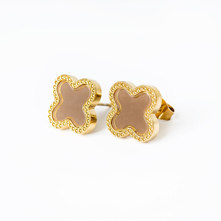 A close up view of brown colour Fiorella Earrings standing in the center of the image against a white background 