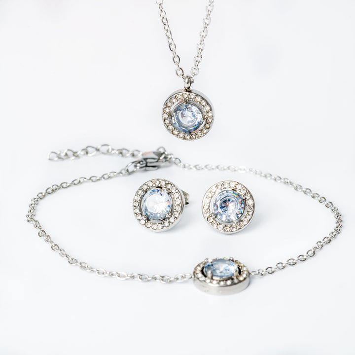 A silver necklace with two round cubic zirconia charms and a chain-link design.