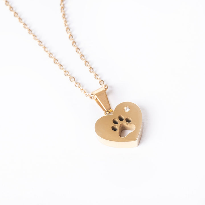 A paw necklace standing against a white background 