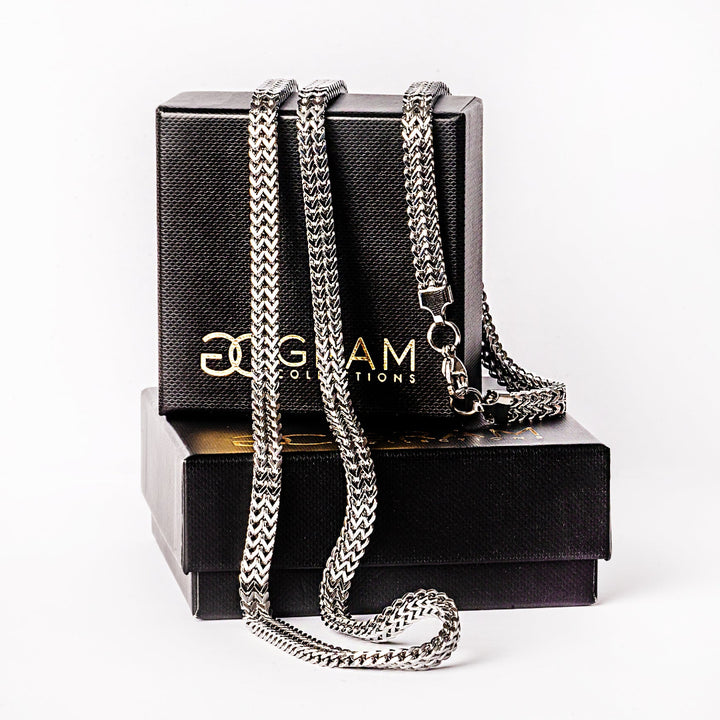 Sienna Silver Necklaces placed on its uniquely made box standing against a white background. 