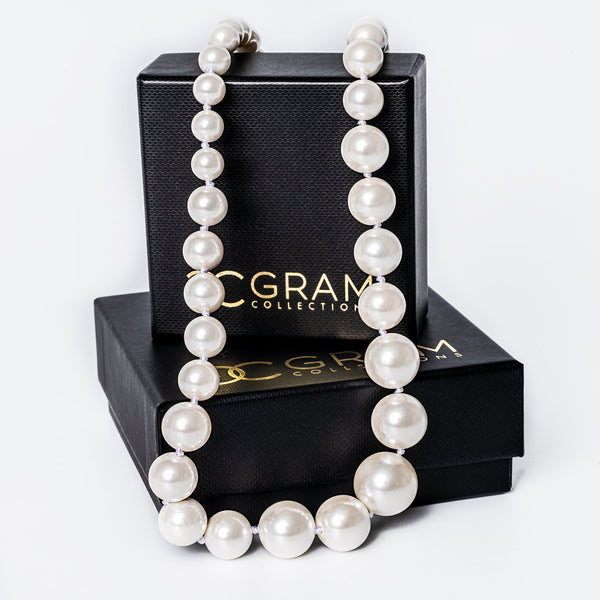 Starlight Necklace placed on its box, surrounded by a white background 