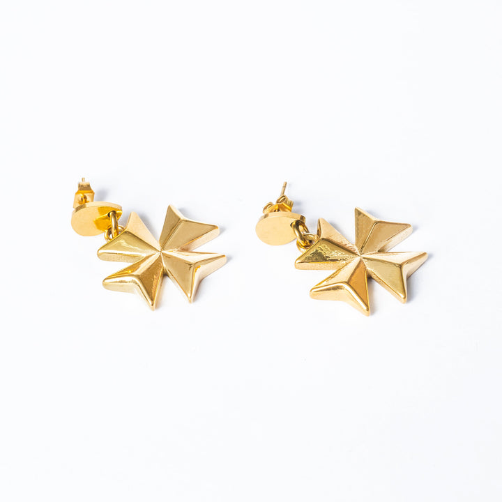 A close up view of The Eight Pointed Cross Earrings standing in the center of the image against a white background. 