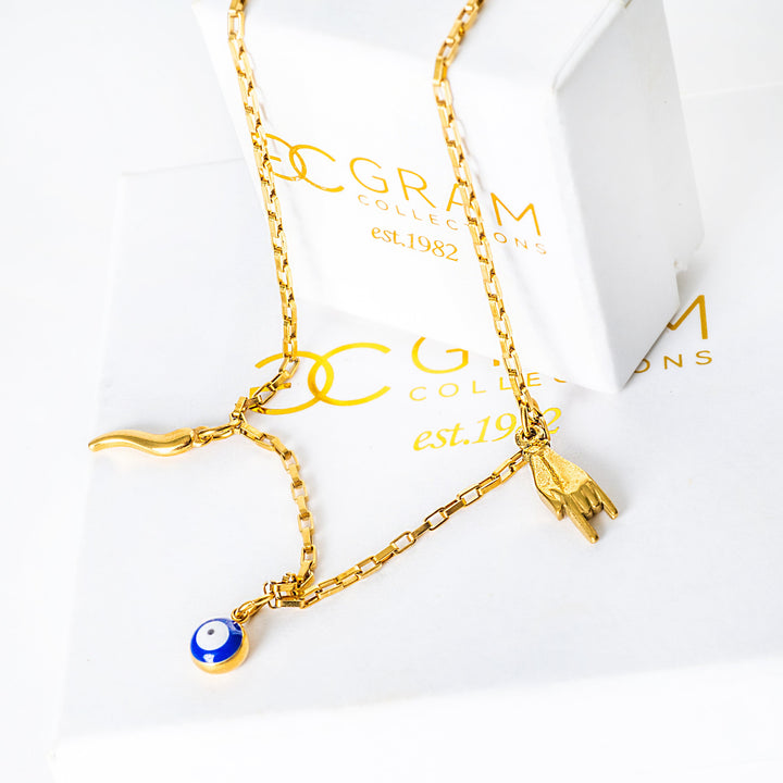 Xorti necklace with a blue pendant on a white background, placed on its box with 'G. Gram' branding.