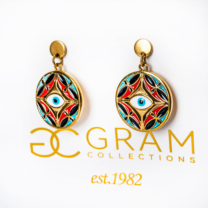 Decorative Ghajn earrings with a colorful design on a white background, featuring the 'Gram Collections' logo.
