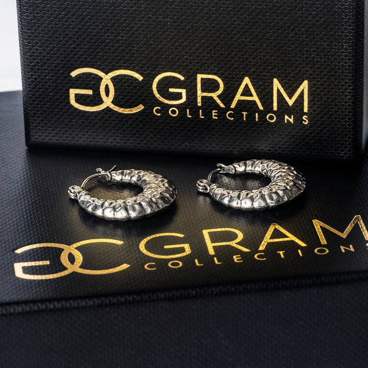 Graziella Silver Earrings placed on its uniquely designed black box. 