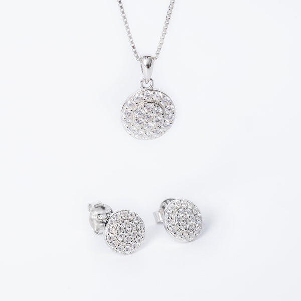 A sterling silver Hazal set including a pendant with a cubic zirconia, a chain, and a pair of earrings, all featuring a silver color and cubic zirconia embellishments.