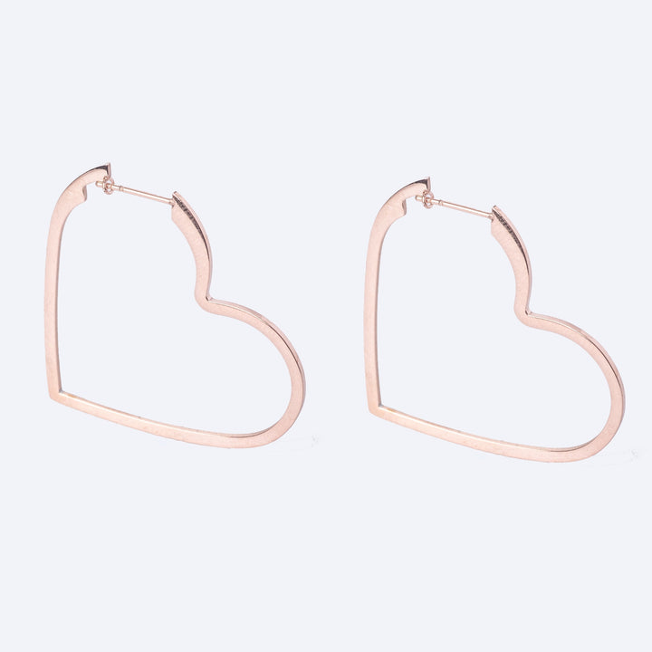 A heath shaped valentina rose gold earrings standing in the center of the image against a white background. 