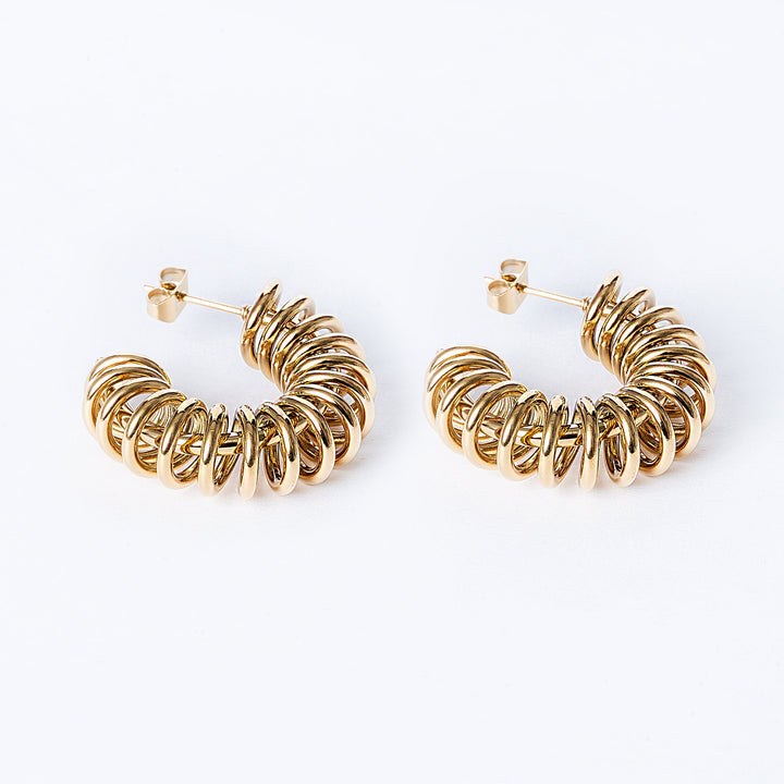 A pair of gold-colored hoop earrings on a white background