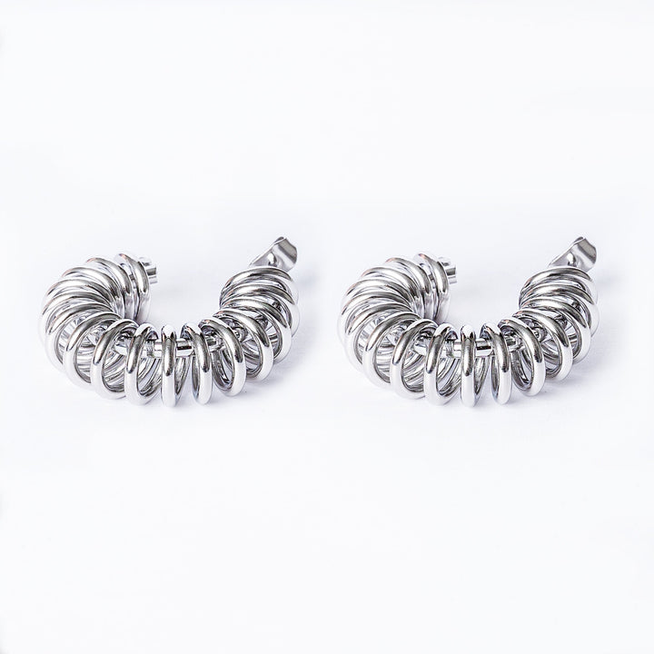 A close up view of Ines Silver Earrings standing in the center of the image against a white background. 