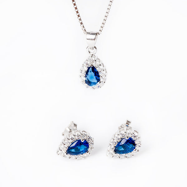 An Irene set - sterling silver jewelry including a pendant with a blue stone and chain, accompanied by a pair of earrings with similar blue stones.