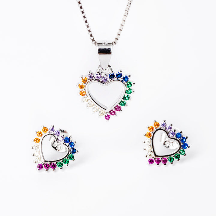 A set of sterling silver jewelry including a pendant, chain, and earrings, adorned with colorful cubic zirconia in a heart shape design.