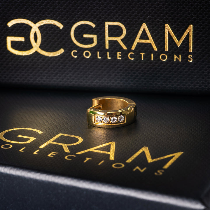 Jacok Gold earrings standing on its box. 