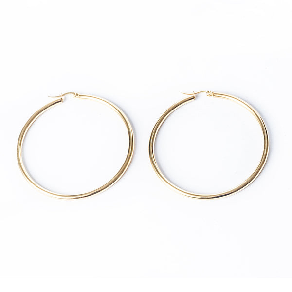 A close u view of Joan Earrings standing in the center of the image against a white background. 