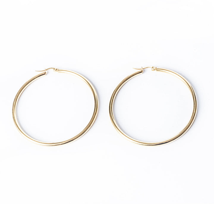 A close u view of Joan Earrings standing in the center of the image against a white background. 
