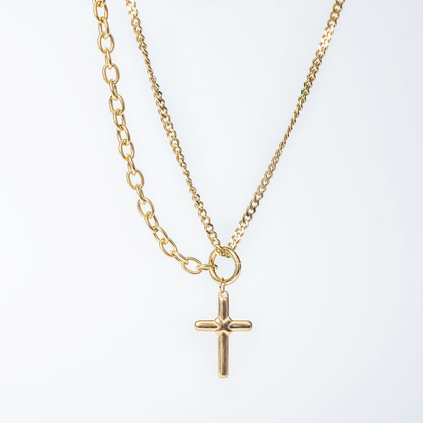 Joanie gold necklace with layered chains and a small cross pendant