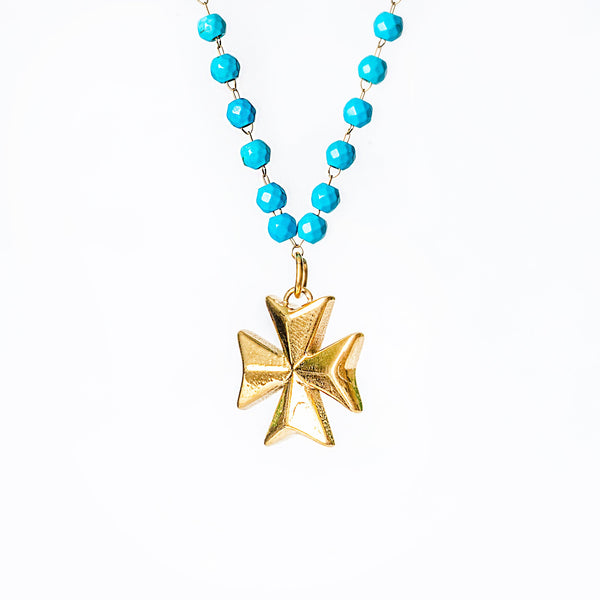 Khali Necklace with turquoise beads and a gold Maltese cross pendant on a white background