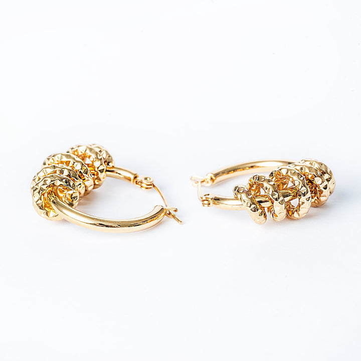 A close up view of Karen Earrings standing in the center of the image against a white background. 
