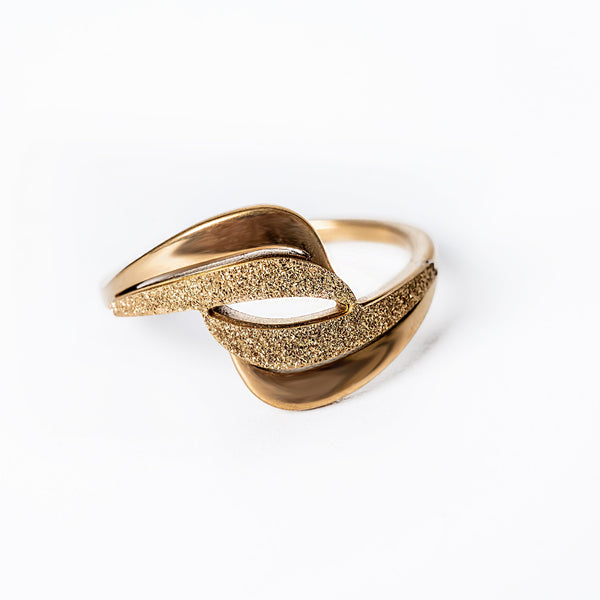 A close up view of Kaycee Gold Ring standing in the center of the image, against a white background. 