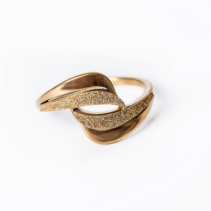 A close up view of Kaycee Gold Ring standing in the center of the image, against a white background. 
