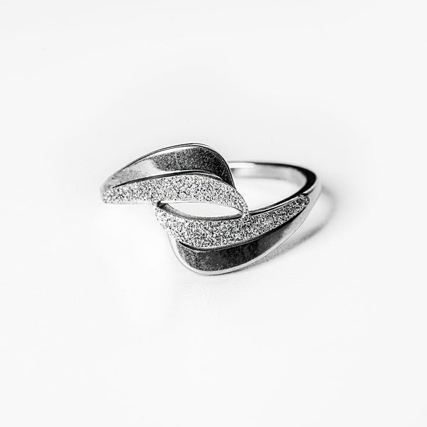 A silver Kaycee ring with a textured band and a shiny, silver-colored top.