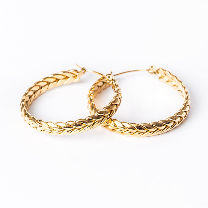 A close up view of Kelly Earrings standing in the center of the image against a white background. 