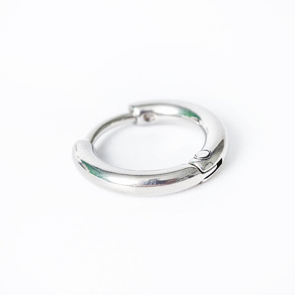 A close up look of Kevin earrings standing against a white background. 