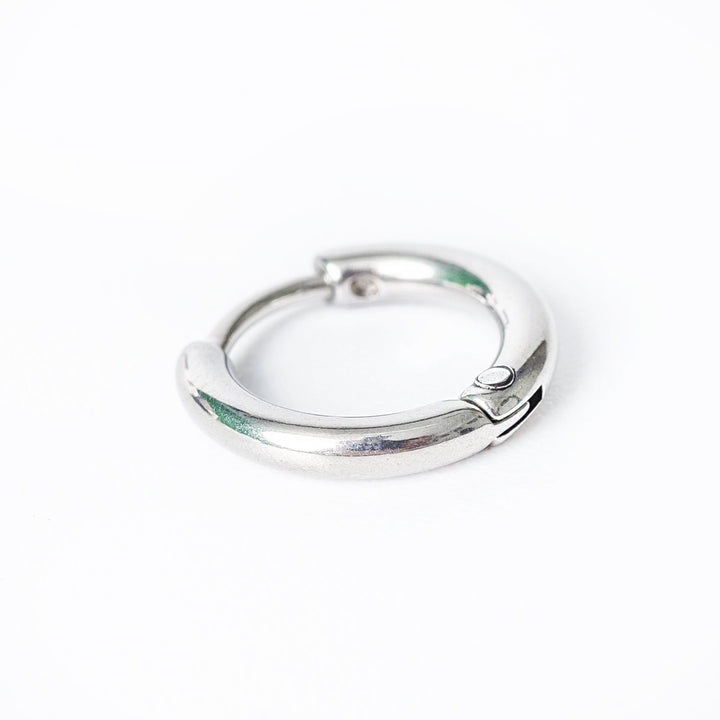 A close up look of Kevin earrings standing against a white background. 