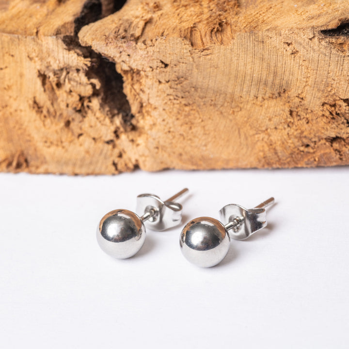 A close up view of kim earrings in silver colour. 