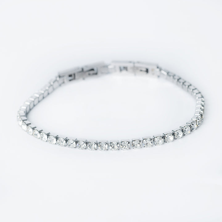 Close up of the silver Kyonne diamond tennis bracelet on a white background
