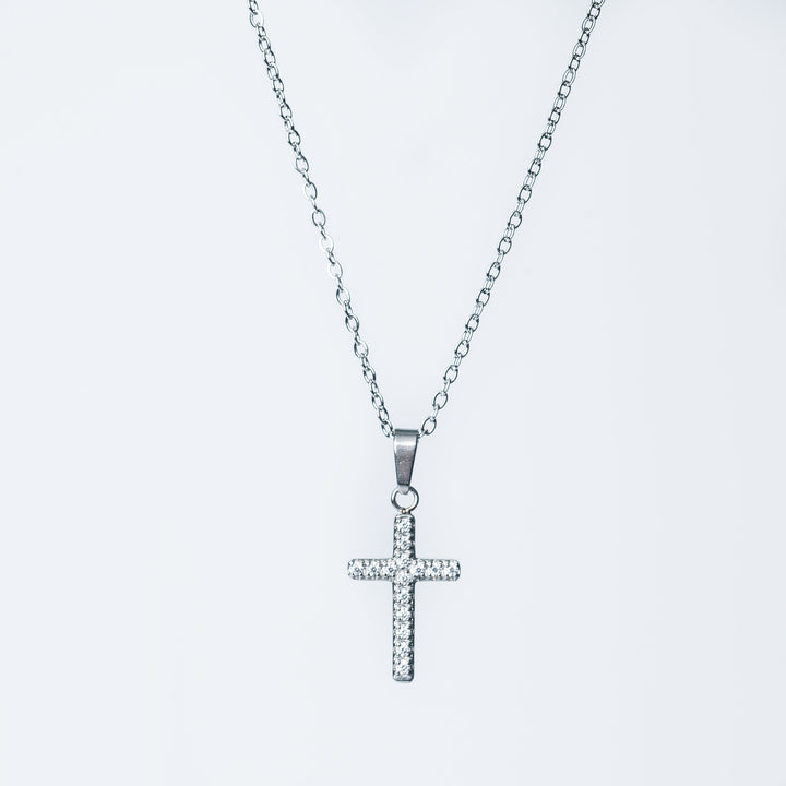 Silver Kyonne cross necklace with clear diamonds shown on a white background